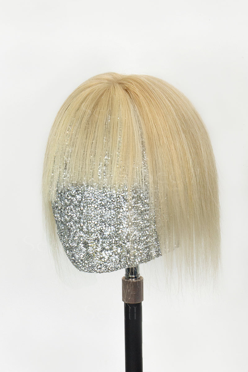 A handcrafted human hair topper with bangs in light blonde color, displayed on a mannequin head.