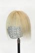 A handcrafted human hair topper with bangs in light blonde color, displayed on a mannequin head.
