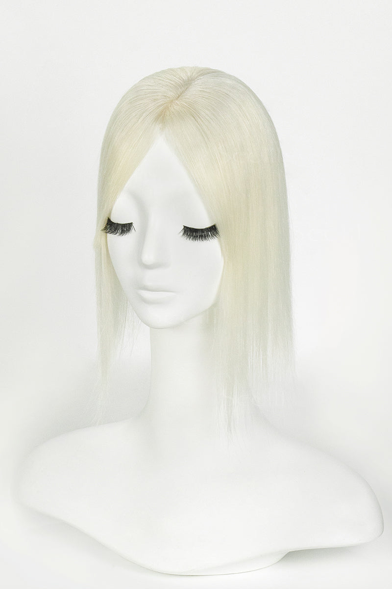 Blonde wig on a mannequin head against a white background