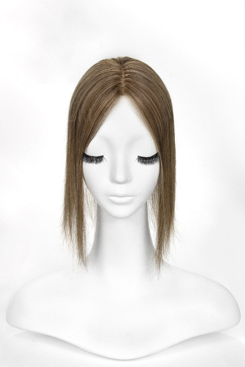 Mannequin head with a brown topper on a white background