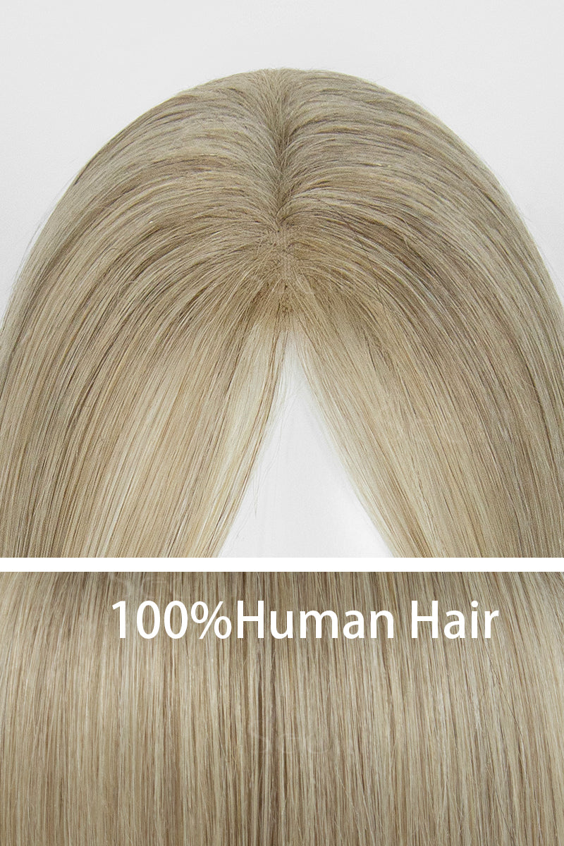 Close-up of a beige blonde hair topper showing the center part and straight human hair strands.