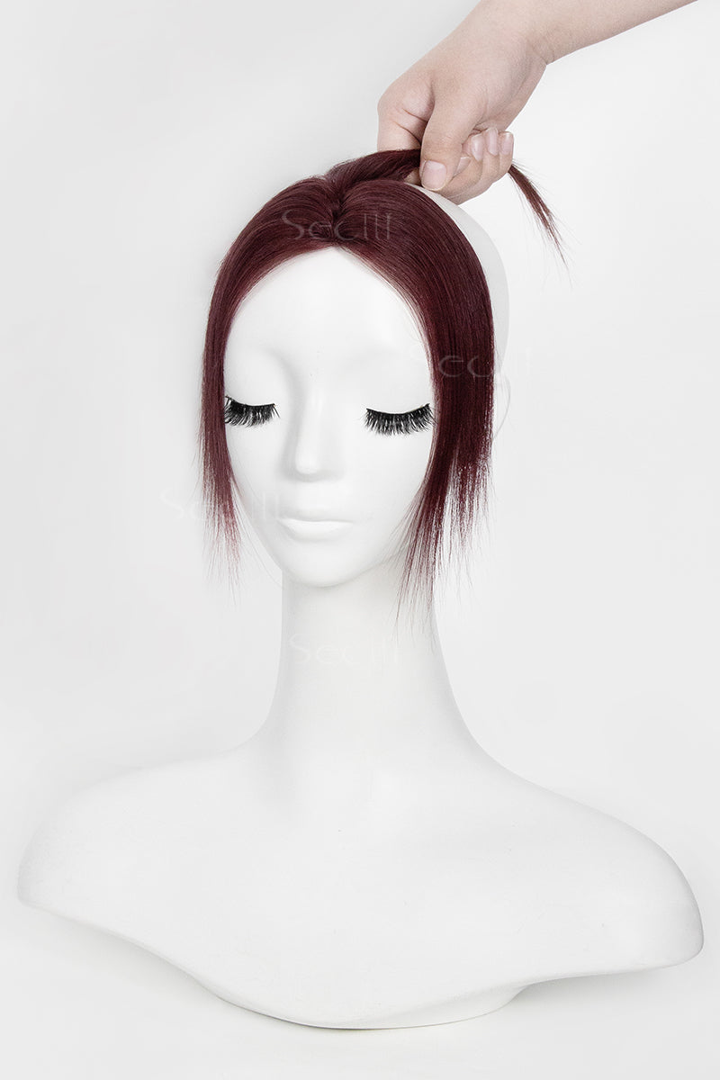 Mannequin head with burgundy topper on a white background