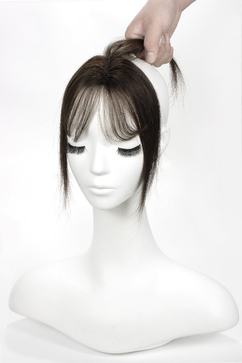Mannequin head with a brown Topper on a white background
