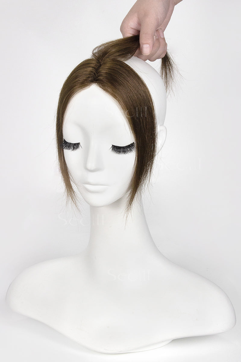 Mannequin head with a brown topper on a white background