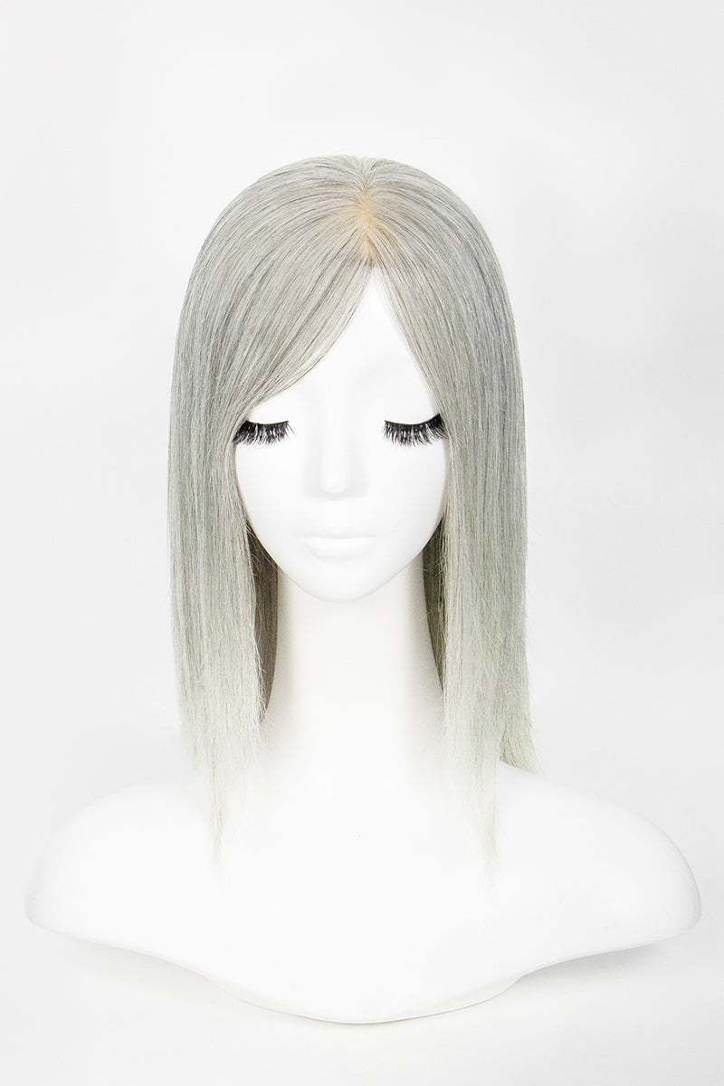 Silver wig on a mannequin head against a white background