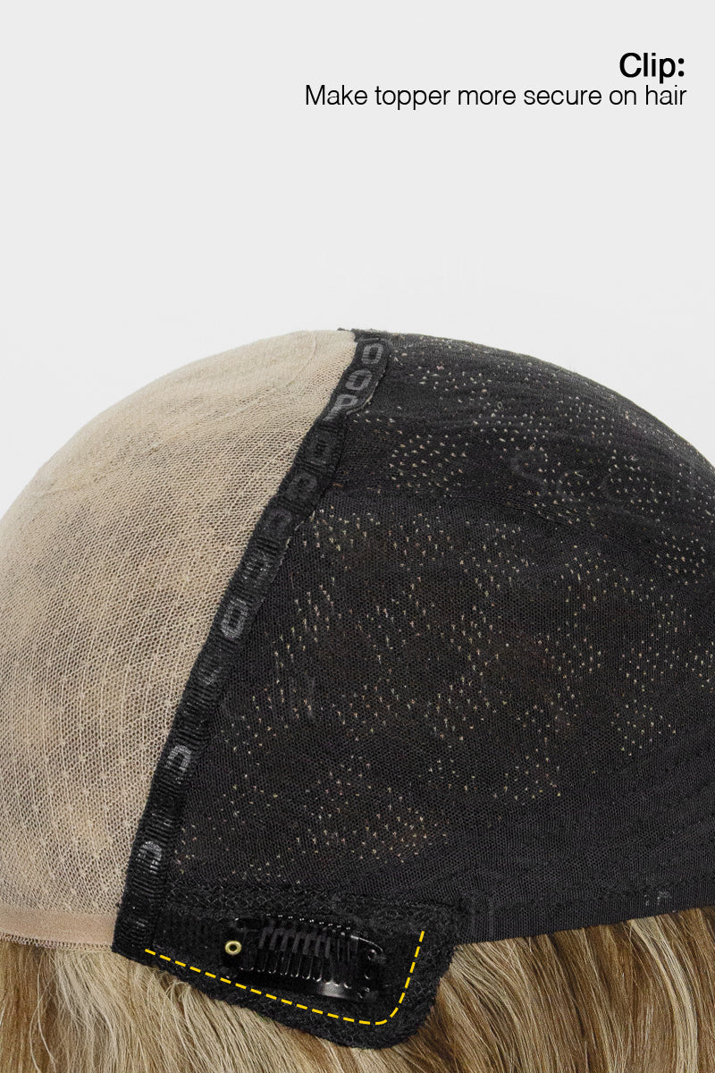 Close-up of a hairpiece with a clip on a white background