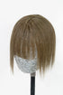 A mannequin head displaying light chestnut brown human hair bangs with a sparkly hairpiece on top.