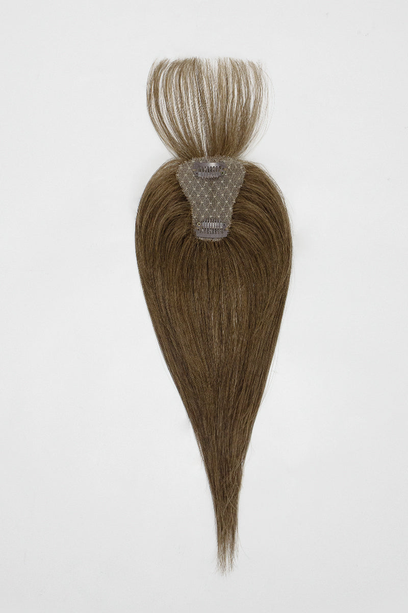 Brown hair topper with a clip on a white background