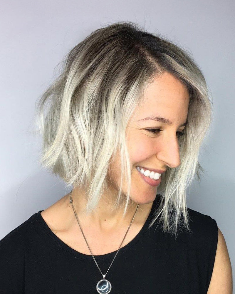 Woman with a stylish haircut against a plain background