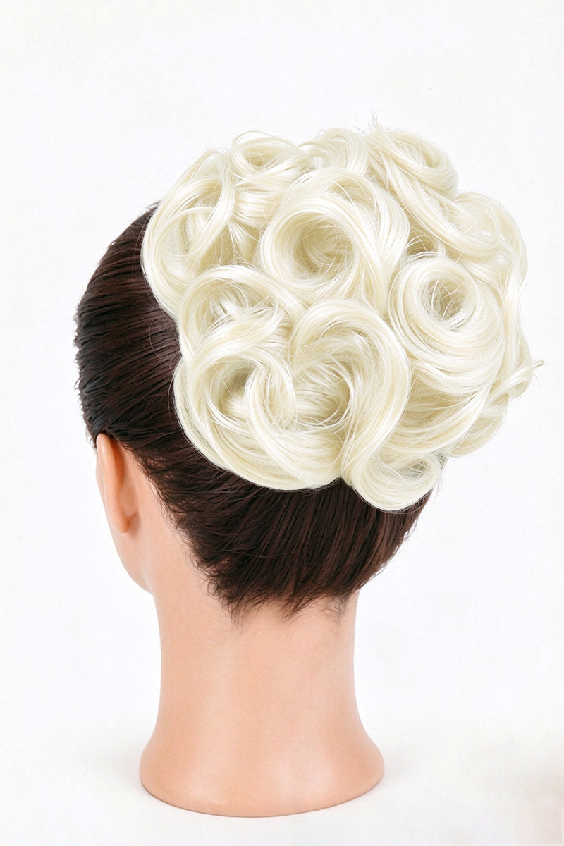 Back view of a white blonde curly bun hairpiece worn over a dark hair updo on a mannequin.