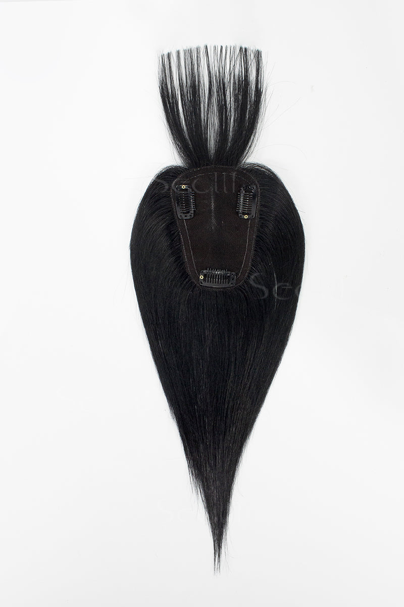 A mannequin head showcasing a dark black human hair topper with bangs.