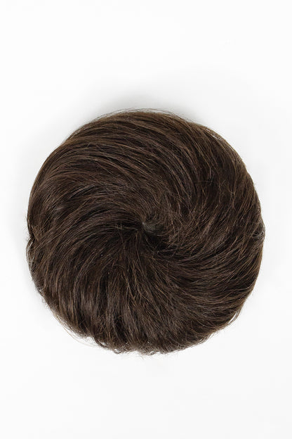 A dark brown hairpiece or hair bun shown from a top-down view on a plain white background.