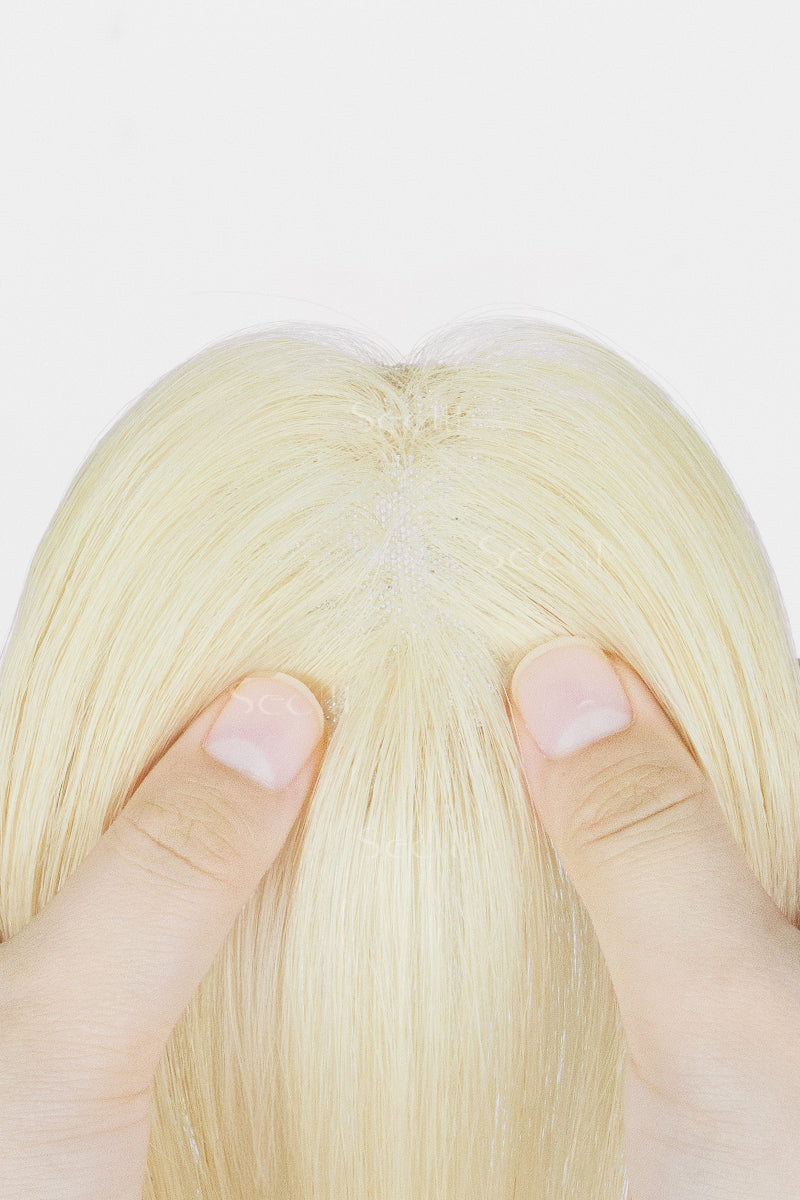 Close-up of a hand holding Magic Pixie Topper Platinum Blonde 