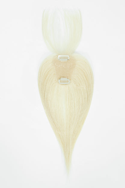 A single light blonde hair extension piece with a tapered tail and two metal clip attachments, shown against a plain white background.