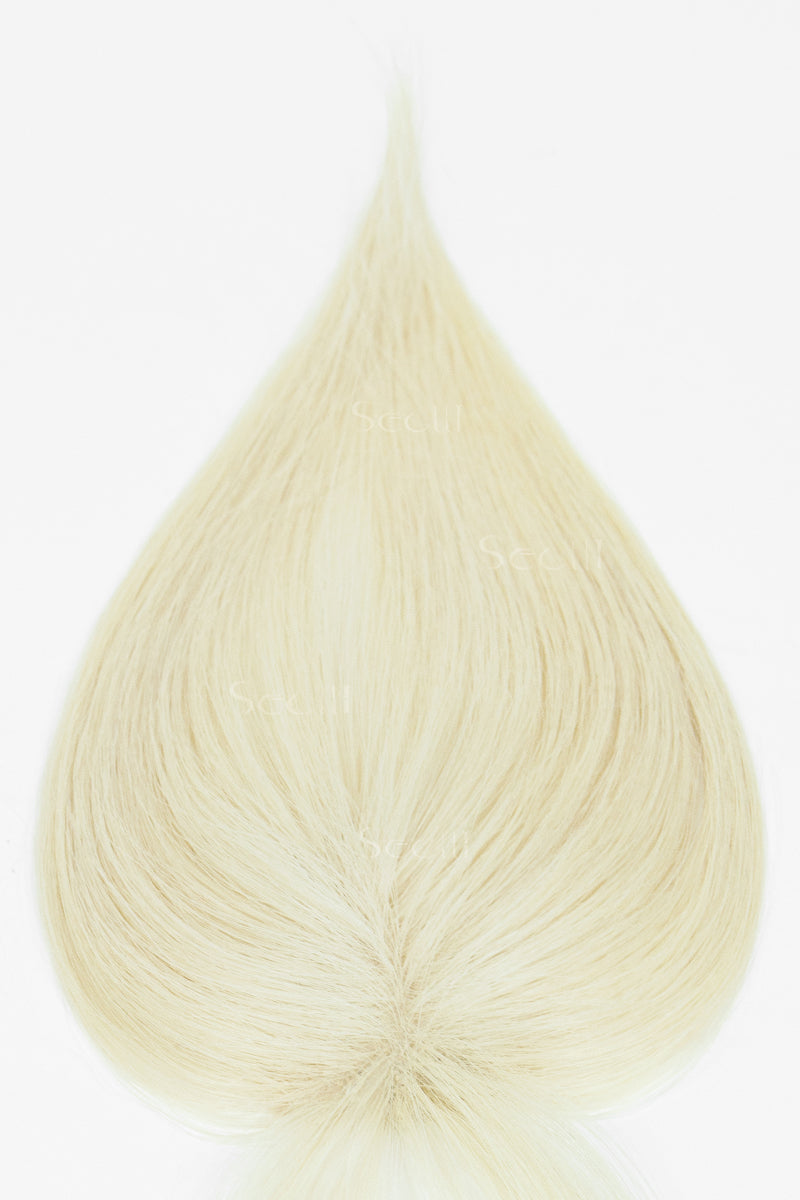 A teardrop-shaped swatch of light platinum blonde hair on a plain white background, showing the texture and color of the hair.