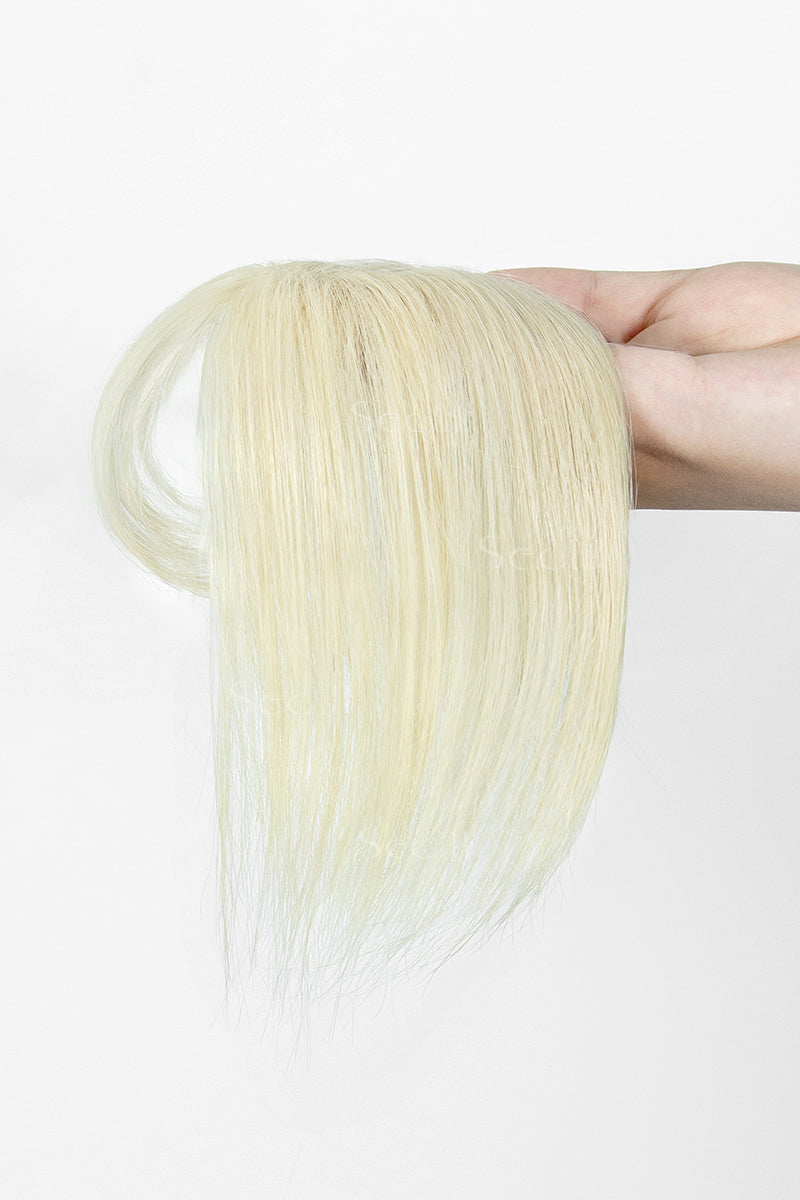 A hand holding a straight, wispy blonde hair extension or wig piece against a plain white background.