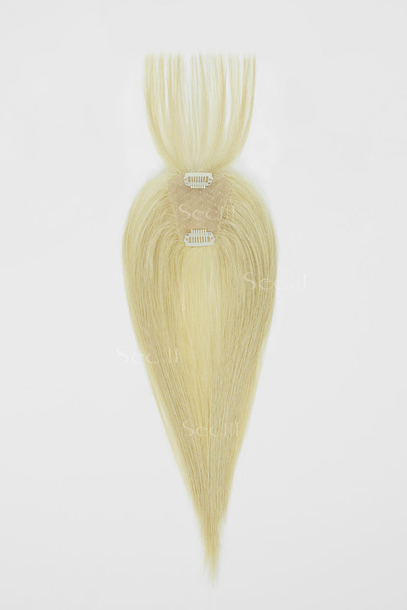 A single clip-in hair extension piece in a light blonde shade, shown against a plain white background. The hair is styled in a straight, tapered shape with two silver metal clips visible at the base.
