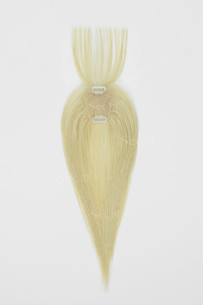 A single clip-in hair extension piece in a light blonde shade, shown against a plain white background. The hair is styled in a straight, tapered shape with two silver metal clips visible at the base.