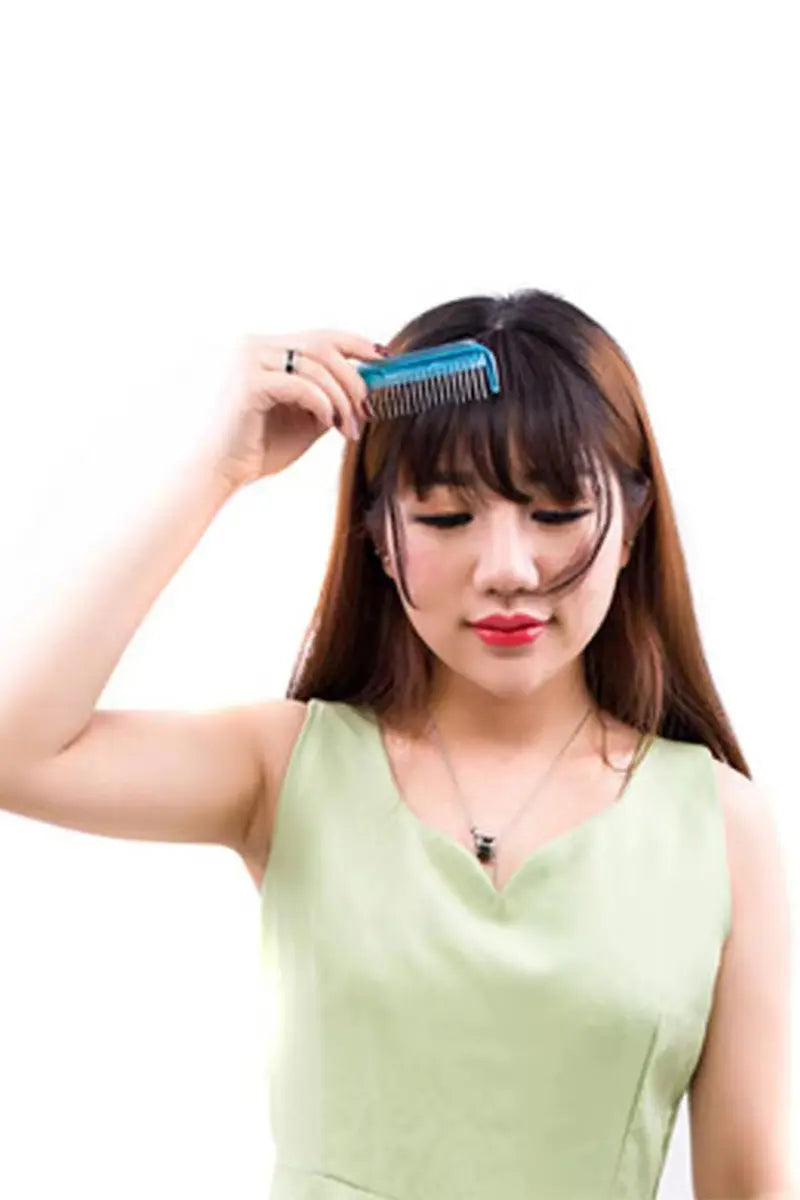 a woman comb the hair bangs