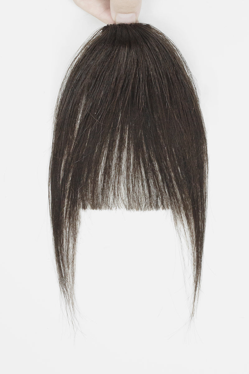 A dark brown hair extension piece with straight, shoulder-length bangs held up by a hand against a plain white background.