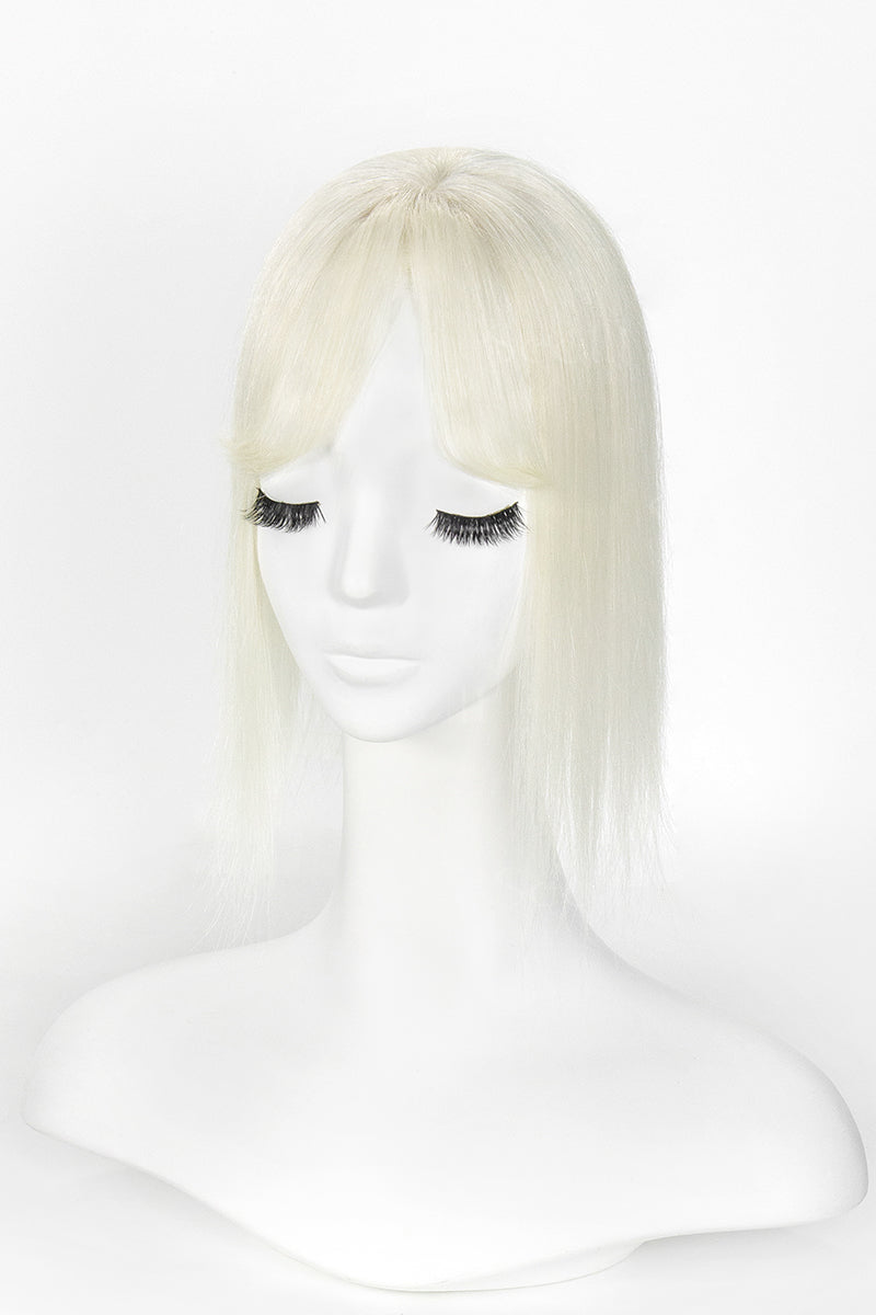 Blonde wig on a mannequin head against a white background
