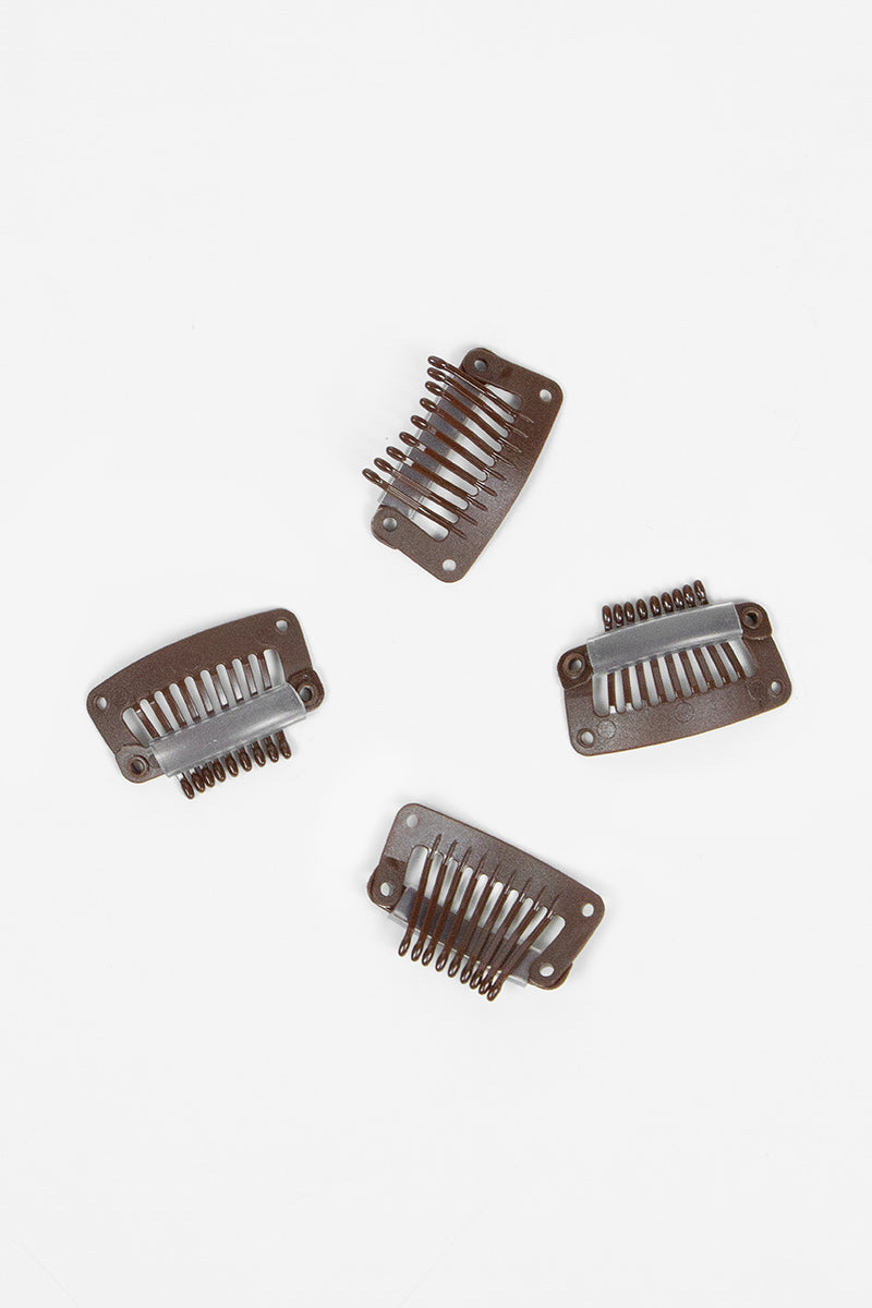 Four plastic hair combs on a white background