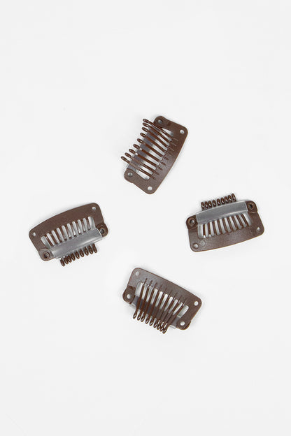 Four plastic hair combs on a white background