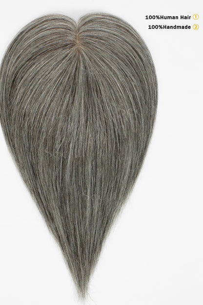 Medium grey hair topper laid flat with a center part and text highlighting handmade human hair construction.