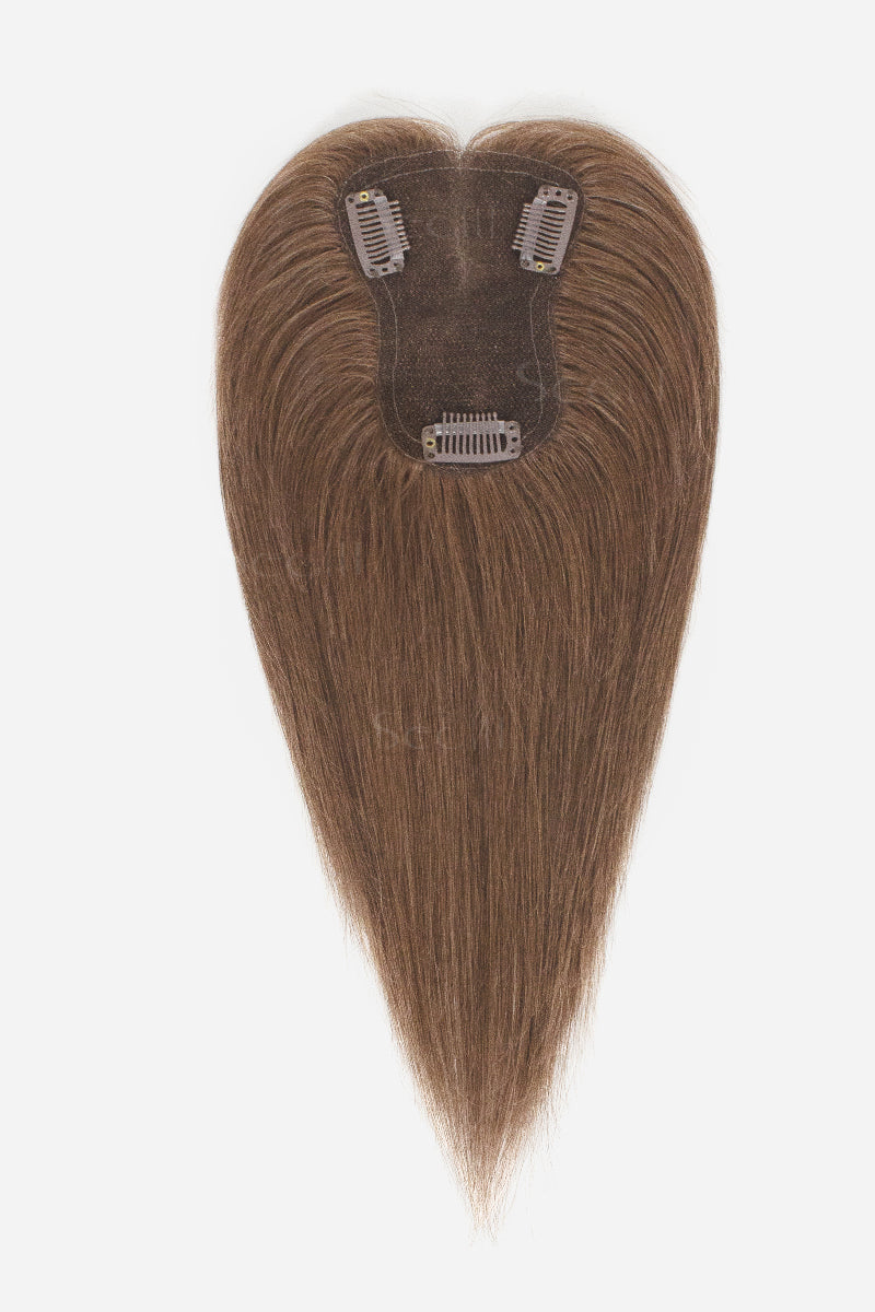 A long, straight hair clip-in extension piece with a heart-shaped top and tapered bottom, shown against a plain white background. The hair is a medium brown shade, and the attachment clips are visible at the top.