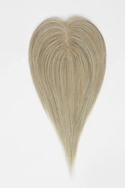  Beige blonde hair topper laid flat, showing the center part and straight, tapered lengths.