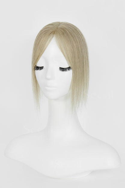 Front view of a beige blonde hair topper with a center part and face-framing strands on a mannequin.