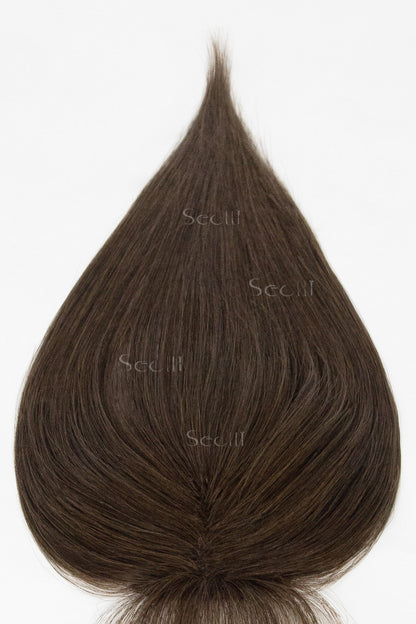 Brown hair topper on a white background