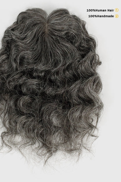 Gray wavy hairpiece on a white background with text indicating 100% human hair and 100% handmade.