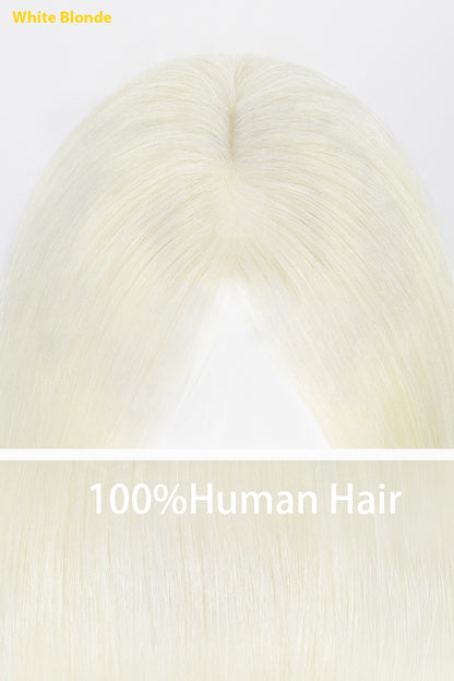 A close-up of a white blonde hair extension or wig top section with a center part, shown on a plain light background with text reading &