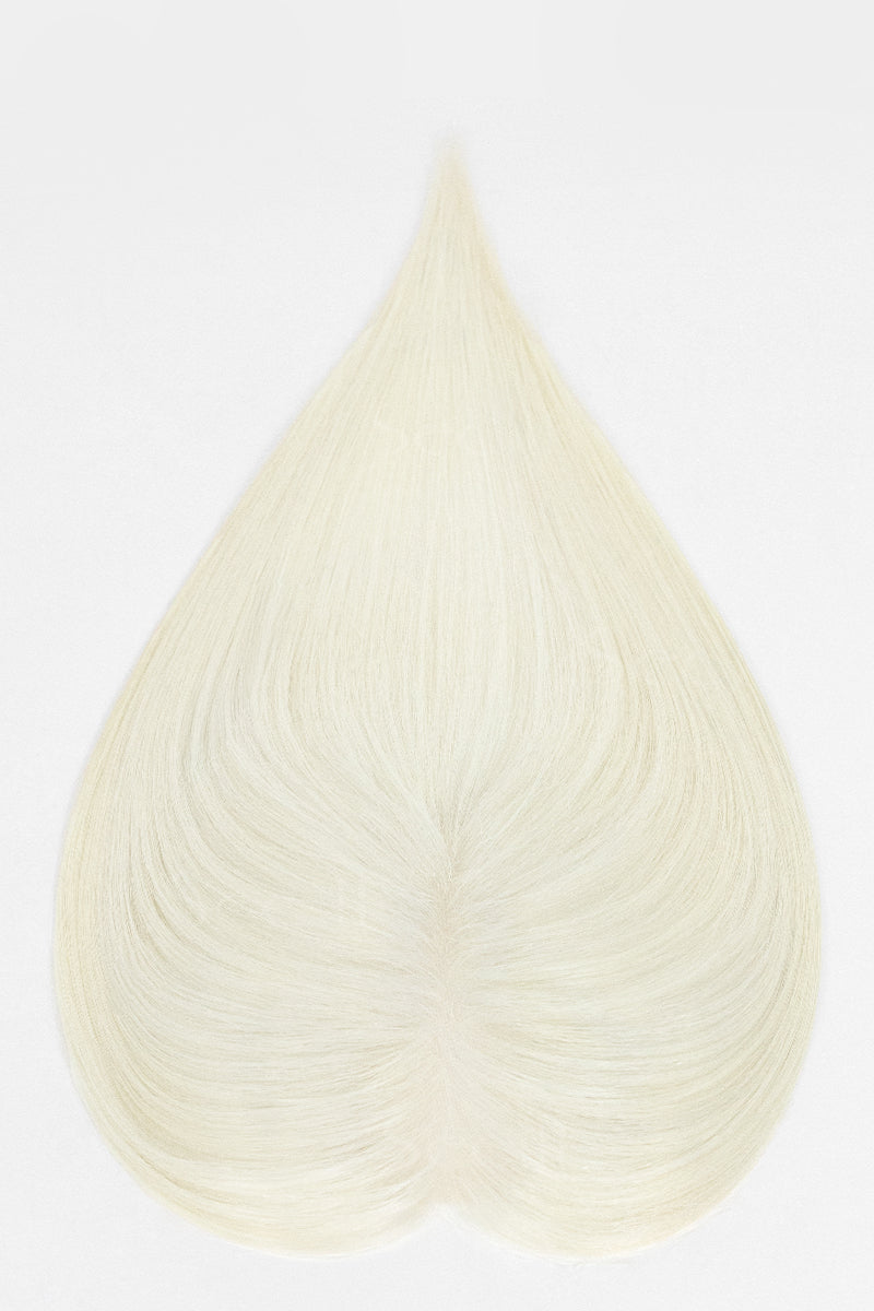 A heart-shaped hair extension or wig piece in a very light cream or off-white shade, displayed against a plain white background.