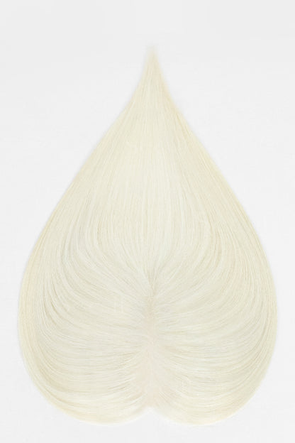 A heart-shaped hair extension or wig piece in a very light cream or off-white shade, displayed against a plain white background.