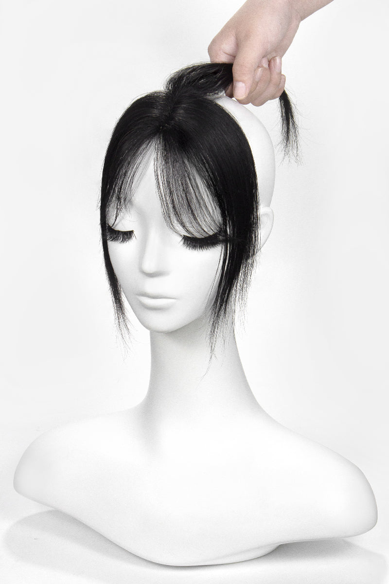 Mannequin head with a black pixie topper on a white background