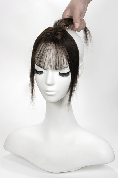 Mannequin head with a brown Topper and bangs on a white background