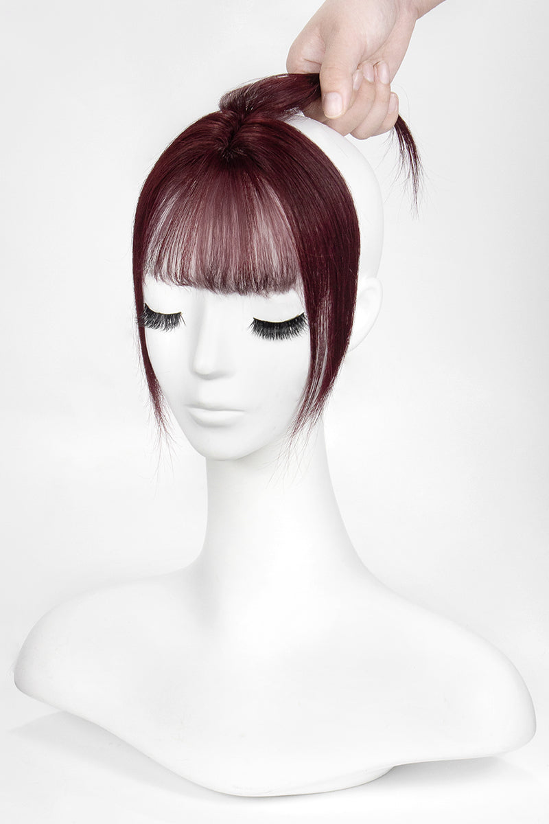 Mannequin head with a burgundy wig on a white background