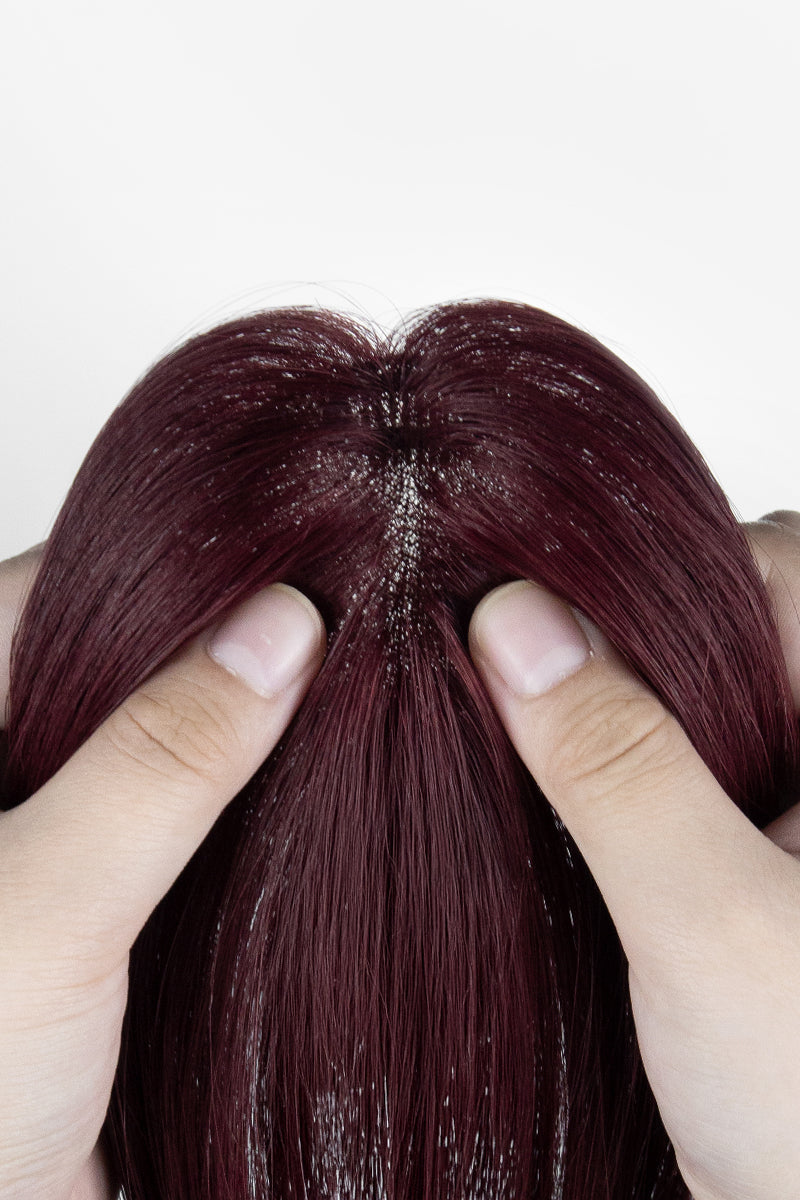 Close-up of a person holding a section of Wine Red 