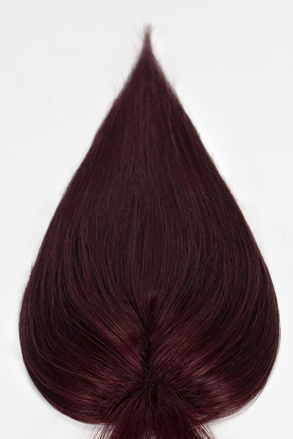 Dark burgundy hair topper on a white background