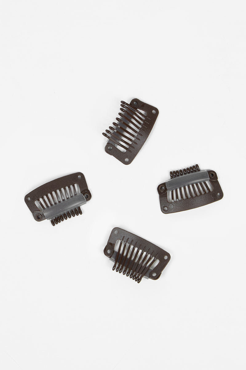 Four dark brown hair combs on a white background