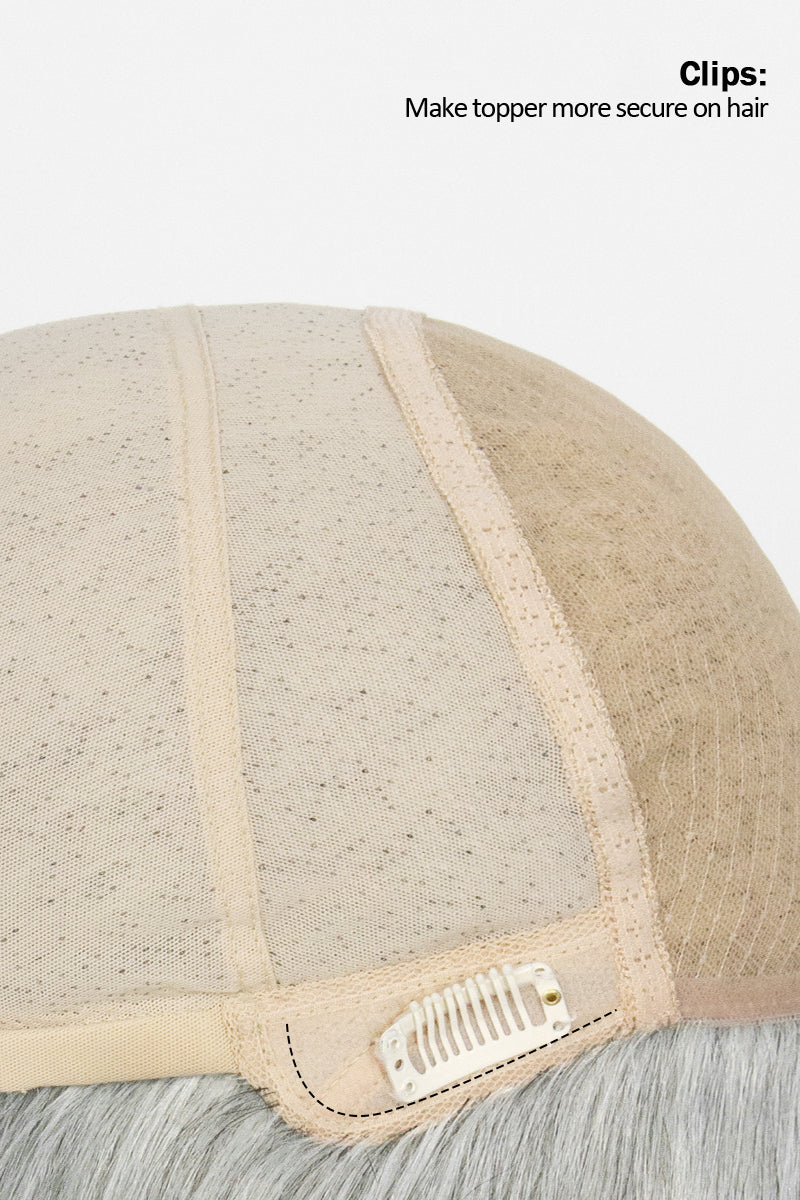 Close-up of a beige hairpiece with clips on a white background