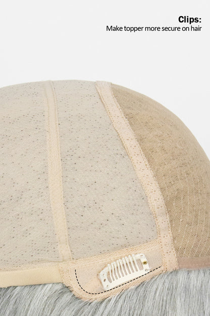 Close-up of a beige hairpiece with clips on a white background