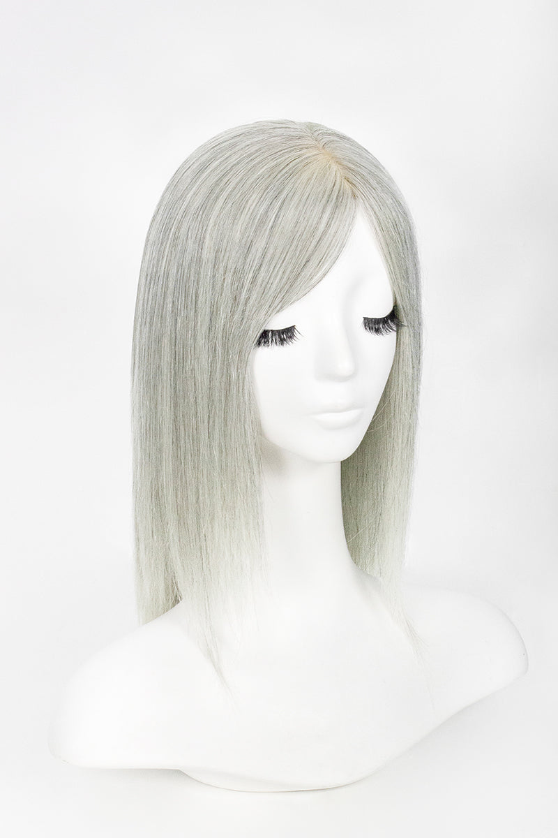 Silver wig on a mannequin head against a white background