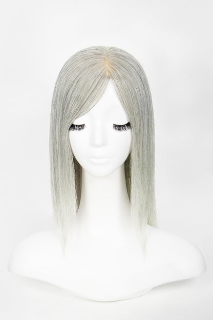Silver wig on a mannequin head against a white background