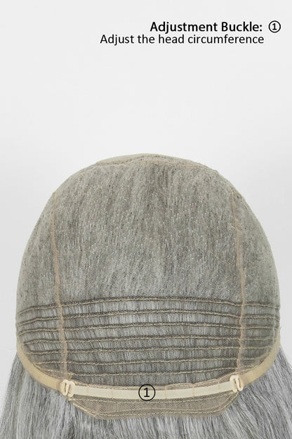Close-up of the underside of a gray wig with visible internal banding and an adjustment buckle strap, plus text at the top reading &