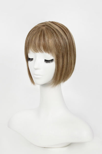 Mannequin head with a brown wig on a white background