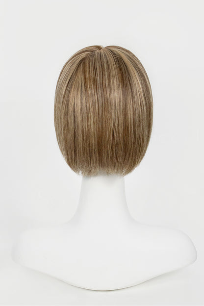 Brown bob wig on a mannequin head against a white background