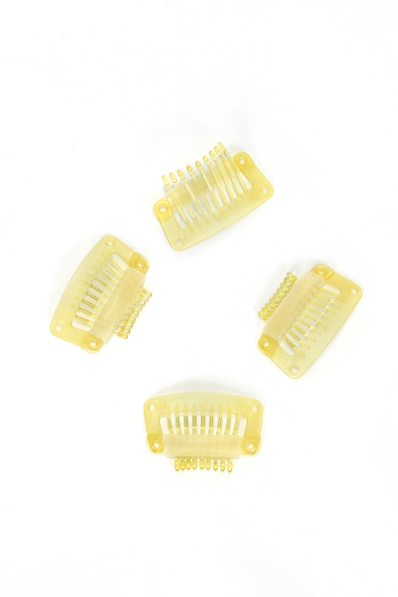 Four yellow hair combs on a white background